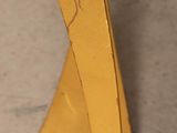 yellow metal table with curved legs and a glass top