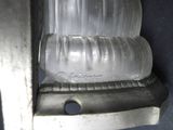an image of a close up of a glass bottle holder