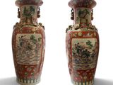 pair of chinese vases with asian scenes on them against a white background