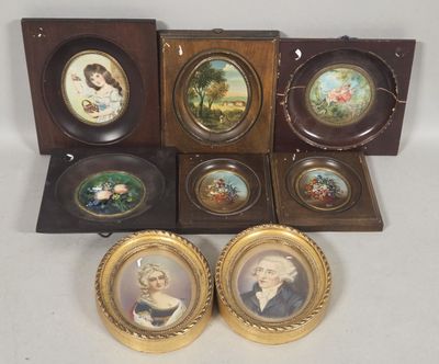 six framed miniature portraits of people in a wooden case