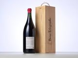 a bottle of wine sitting next to a wooden box