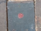 a book on the floor with a red dot on it