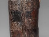 an old wooden bucket with a design on the side