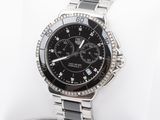a close up of a watch on a white pillow
