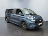 the blue van is parked in a large room with a black floor