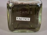 a bottle of perfume sitting on a table with a label on it