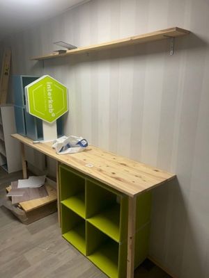 a wooden shelf with a green shelf on top of it
