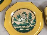 three yellow plates with a picture of a house and a church on them
