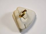 an image of a gold ring sitting on top of a white surface