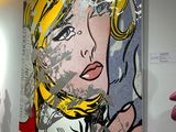 a painting of a woman that is on the wall