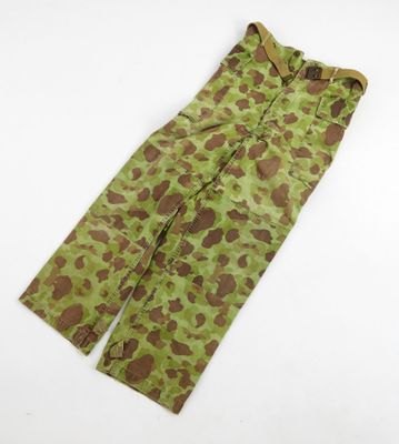 a close up of a camouflage pants on a white surface