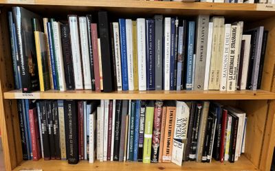 a book shelf with many books on it in a room