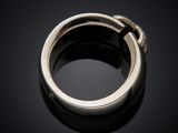 a close up of a silver ring on a black surface