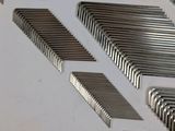 many pieces of metal that are arranged on a white surface