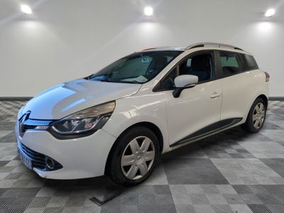 a white car is parked in a room with a checkered floor