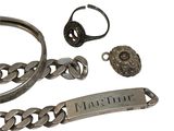 a silver bracelet, ring, and bracelet with a nameplate on it