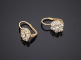a pair of gold and diamond earrings