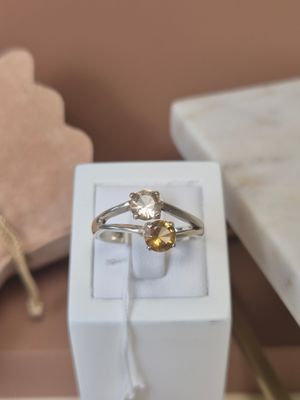 a white box with a ring on it and a gold ring in it