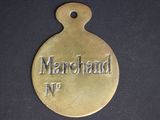 a close up of a brass medal with the name of a man