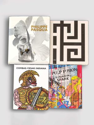 three books are stacked on top of each other on a white surface