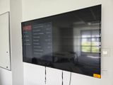 a flat screen tv mounted on a wall in a room