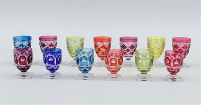 six different colored glasses are lined up in a row