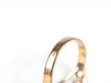 a close up of a gold ring on a white background