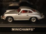 a silver toy car on display in a glass case