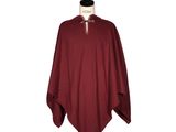 a women ' s burgundy ponche with a white collar and a black top