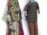 two dolls of a man and a woman are standing next to each other