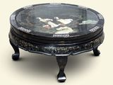 a black table with a glass top with a painting on it
