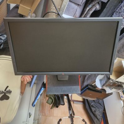 a computer monitor sitting on top of a desk