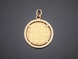 a gold coin pendant with an image of a woman on it