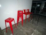 three red stools sitting next to each other in a room