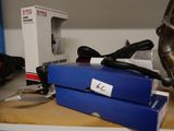 a blue box with a pair of scissors in it on a table