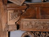 a close up of a wooden bed with carvings on the headboard