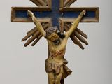 a statue of jesus on a cross with a sunburst in the background