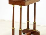 a small wooden table with a wooden top on wheels