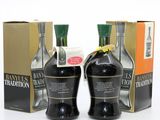 three bottles of brandy sit next to each other in front of a box