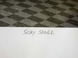 a white piece of paper with writing on it sitting on a checkered floor