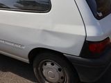 a small white van parked on the side of the road