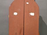 two wooden paddles sitting on top of a wooden stand