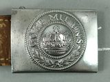 an old belt buckle with a crown on top of it