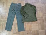 a pair of green pants and a green jacket on the floor