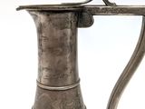 a silver vase with a handle on a white background