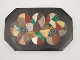 a black tray with a multicolored design on it