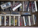 a lot of toy cars in a box on the floor