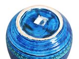 a blue vase with a white square in the center