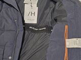 a blue jacket with a tag on it sitting on a table