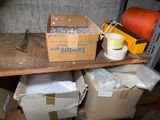 many boxes of items sitting on a shelf in a room